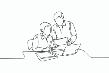 Two people collaborating on a project using a laptop and papers