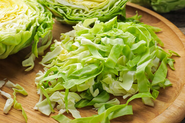 Cut fresh green cabbage on table, closeup