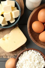 Different dairy products and eggs on grey wooden table, flat lay