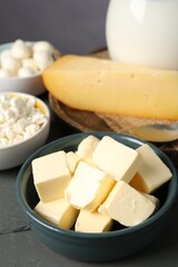 Different dairy products on grey wooden table, closeup