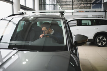 Man buying a car at a showroom