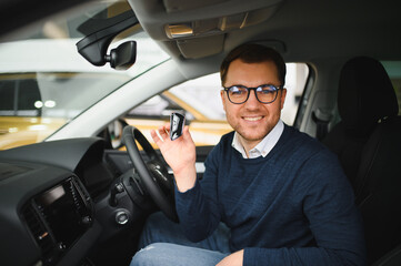 Man buying a car at a showroom