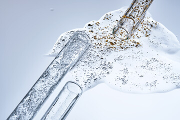 Three test tubes with spilled serums. Demonstration of textures.
