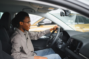 African american Man buying a car at a showroom