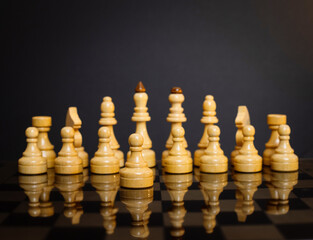 chess pieces on a chessboard on a dark background