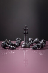 chess piece on purple surface on dark background as business strategy for chess game