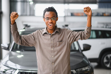 African american Man buying a car at a showroom