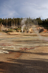 View of the geyser from afar at sunset. Shadows and steam coming out of the geyser are clearly...