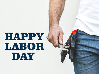 Happy Labor Day. Attractive man and wrench. Closeup, studio shot. Congratulations for family, loved...