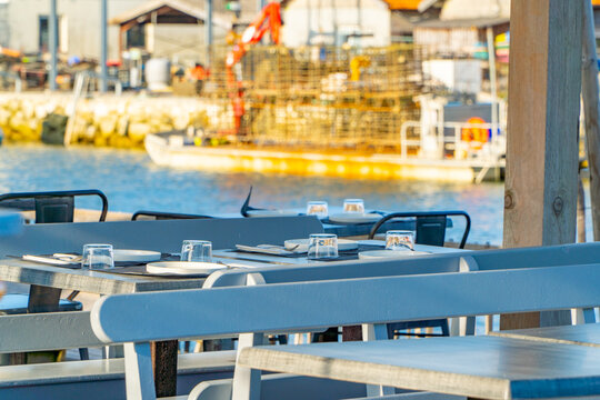 Outdoor oyster restaurant table setup in a industrial dock at french sunset
