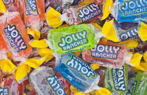Jolly Rancher hard candy in wrappers assorted flavors scattered Houston, Texas USA 07-20-2025.