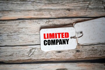 LIMITED COMPANY, text on a small notebook isolated on a wooden table.