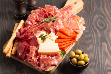 Charcuterie board. Antipasti appetizers of meat platter with salami, prosciutto crudo or jamon and...