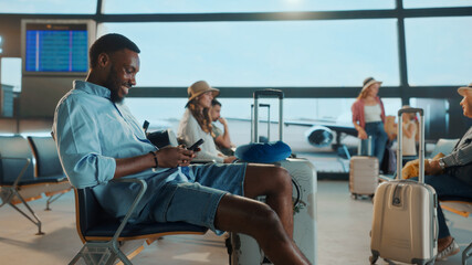 Tourist using smartphone while waiting at the airport gate