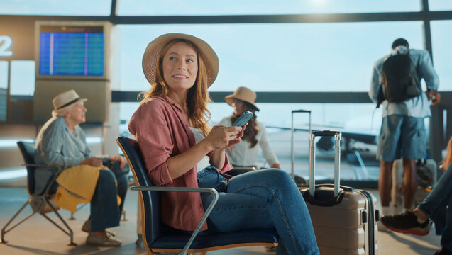 Tourist using smartphone while waiting at the airport gate