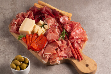 Charcuterie board. Antipasti appetizers of meat platter with salami, prosciutto crudo or jamon and...