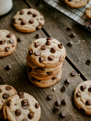 Delicious homemade chocolate chip cookies scattered on a wooden surface