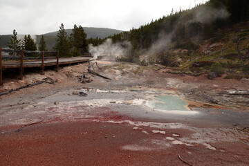 A picturesque landscape of one of the valleys in Yellowstone National Park. Geothermal pools, a...