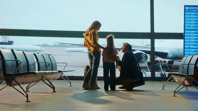 Family saying goodbye at airport before boarding - Powered by Adobe