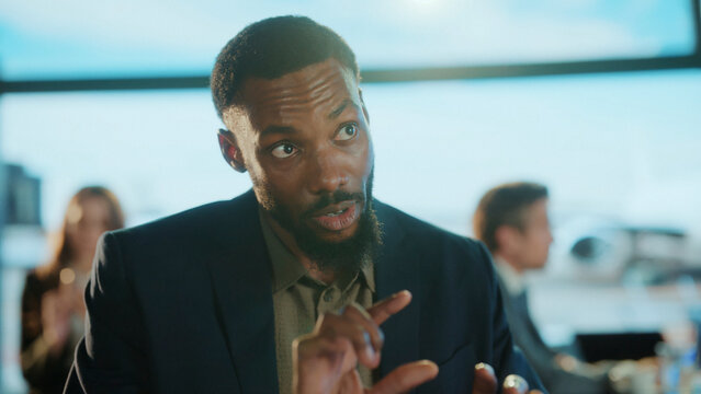 Businessman explaining strategy to colleagues in airport lounge - Powered by Adobe