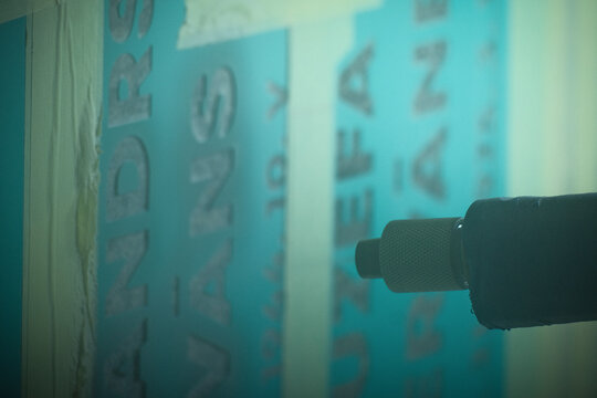 sandblasting, engraving lettering into stone monument