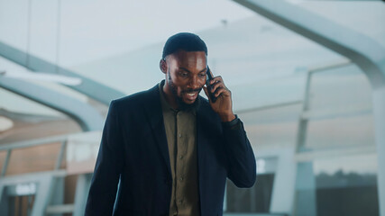 Businessman talking on phone at airport lounge