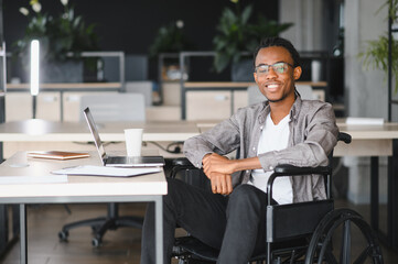 African american student in wheelchair studying at desk