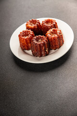 Canneles sweet dessert french cuisine sweets fresh delicious gourmet food background on the table rustic food top view copy space