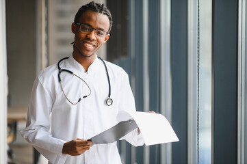 Young male doctor analyzing medical documents