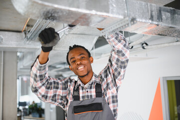 Hvac technician repairing air conditioning ventilation system