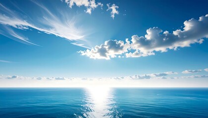 Obraz premium A vast expanse of azure ocean meeting a vibrant sky filled with fluffy clouds