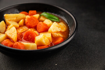 Stewed potatoes with carrots vegetarian side dish fresh delicious gourmet food background on the table rustic food top view copy space keto and paleo diet vegan food