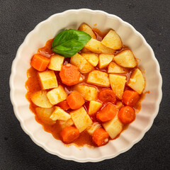 Stewed potatoes with carrots vegetarian side dish fresh delicious gourmet food background on the table rustic food top view copy space keto and paleo diet vegan food