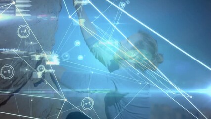 Man crouching, reaching handhold and activating tech nodes and charts tracking climbing performance - Powered by Adobe