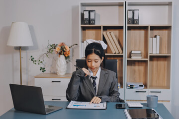 Naklejka premium Young adult happy smiling Hispanic Asian student wearing headphones talking on online chat meeting using laptop in university campus or at virtual office. College female student learning remotely.