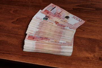  A stack of Russian rubles banknotes on the table. Selective focus