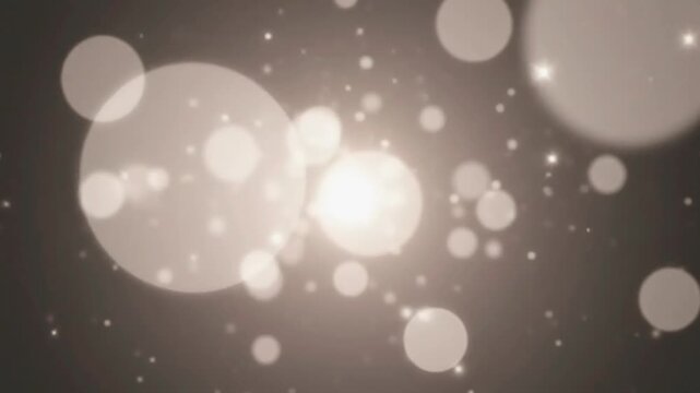 Warm elegant glowing bokeh lights particles abstract background seamless loop with soft focus sparkling shimmering dust for celebrations events and subtle motio