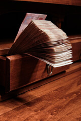 Stack of Russian rubles banknotes in the drawer of the desk. Selective focus