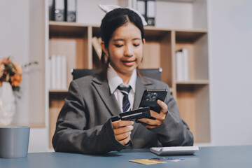 Close up woman hand using credit card and smartphone laptop for buying online shopping