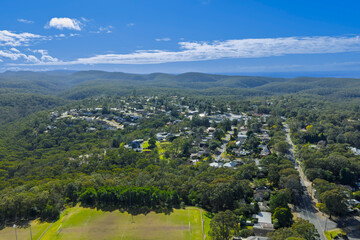 Drone aerial photograph of residential houses amongst lush green foliage in the town of Winmalee in...