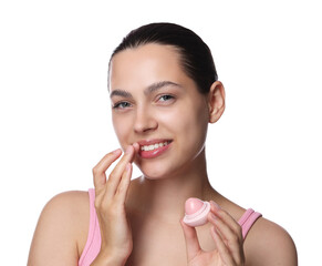Young woman with lip balm on white background
