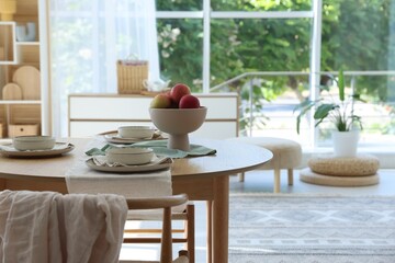 Stylish table setting with fresh fruits and decor in dining room. Interior design