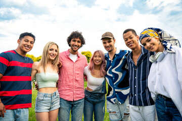 Group of multiethnic teenagers spending time outdoor on a picnic at the park