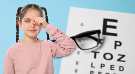 Little girl with eyesight problems and vision test chart on light blue background. Banner design