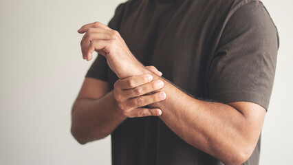 Rheumatism man hand pain from cramp, wrist pain touching massaging, hand holding ache joint