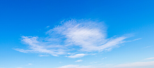 Bright blue sky with sparse white cirrus clouds, creating a sense of spaciousness and serenity