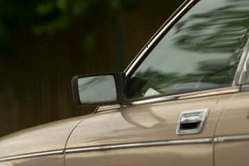This image provides a detailed closeup view of a cars side mirror and the corresponding door...