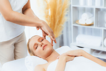 Caucasian woman enjoying relaxing anti-stress head massage and pampering facial beauty skin...