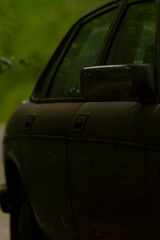 This image features a closeup view of a sleek car door, prominently displayed against an appealing...