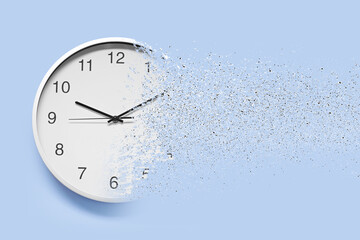 Time running out. Clock dissolving on light blue background